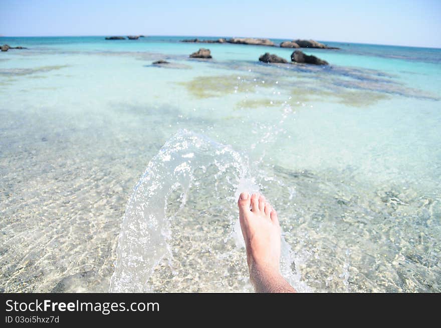 Kicking the water in the beach. Kicking the water in the beach