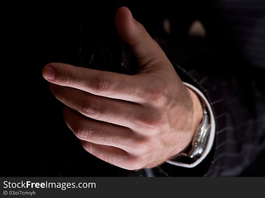 The hands of a businessman carrying a briefcase