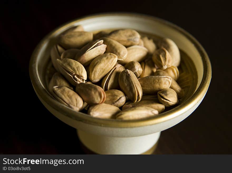 Pistacios in the bowl, black background