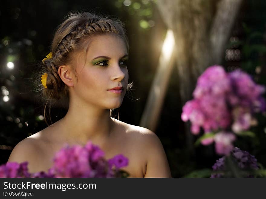 Girl in the garden on dark background