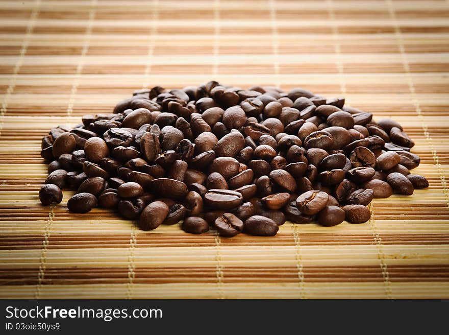 Handful aromatic coffee beans on a table