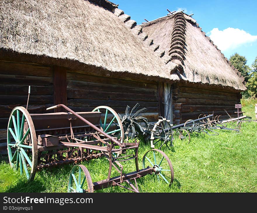 The old wooden barn and the display of agricultural equipment in the Open-Air Museum of the Lublin Region's Village, Lublin, Poland. The old wooden barn and the display of agricultural equipment in the Open-Air Museum of the Lublin Region's Village, Lublin, Poland