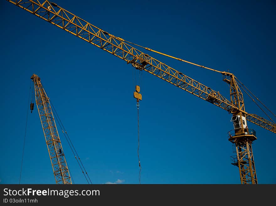 Working crane with blue sky and clouds