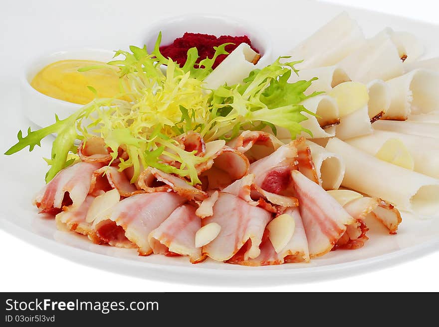 Bacon, sliced​​, garlic, mustard and grated beets on a plate