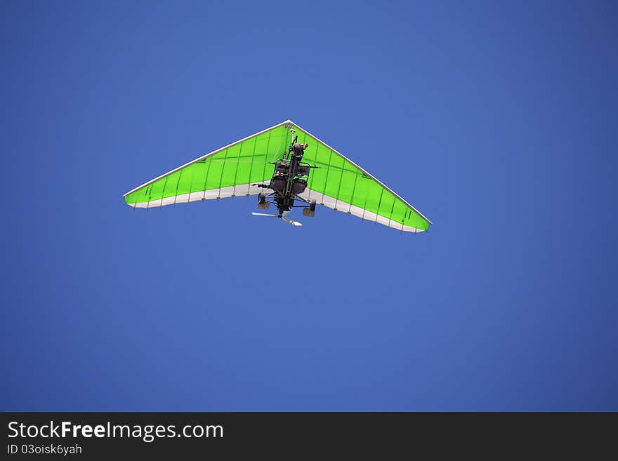 Hang gliding in the blue sky.