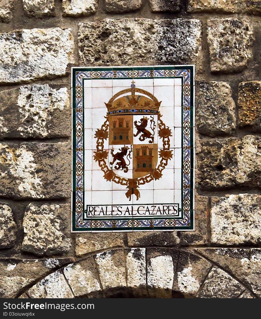 A wall with the coat of arms of Real Alcazar. A wall with the coat of arms of Real Alcazar