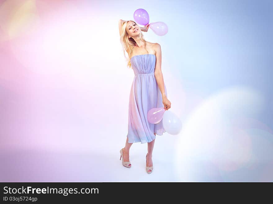 Woman wishes happy birthday, holding balloons in her hands. Woman wishes happy birthday, holding balloons in her hands