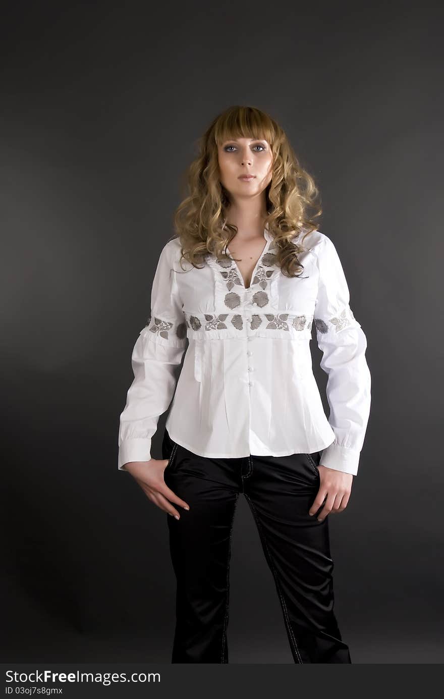 Portrait of the girl of model with a voluminous hair in a white shirt