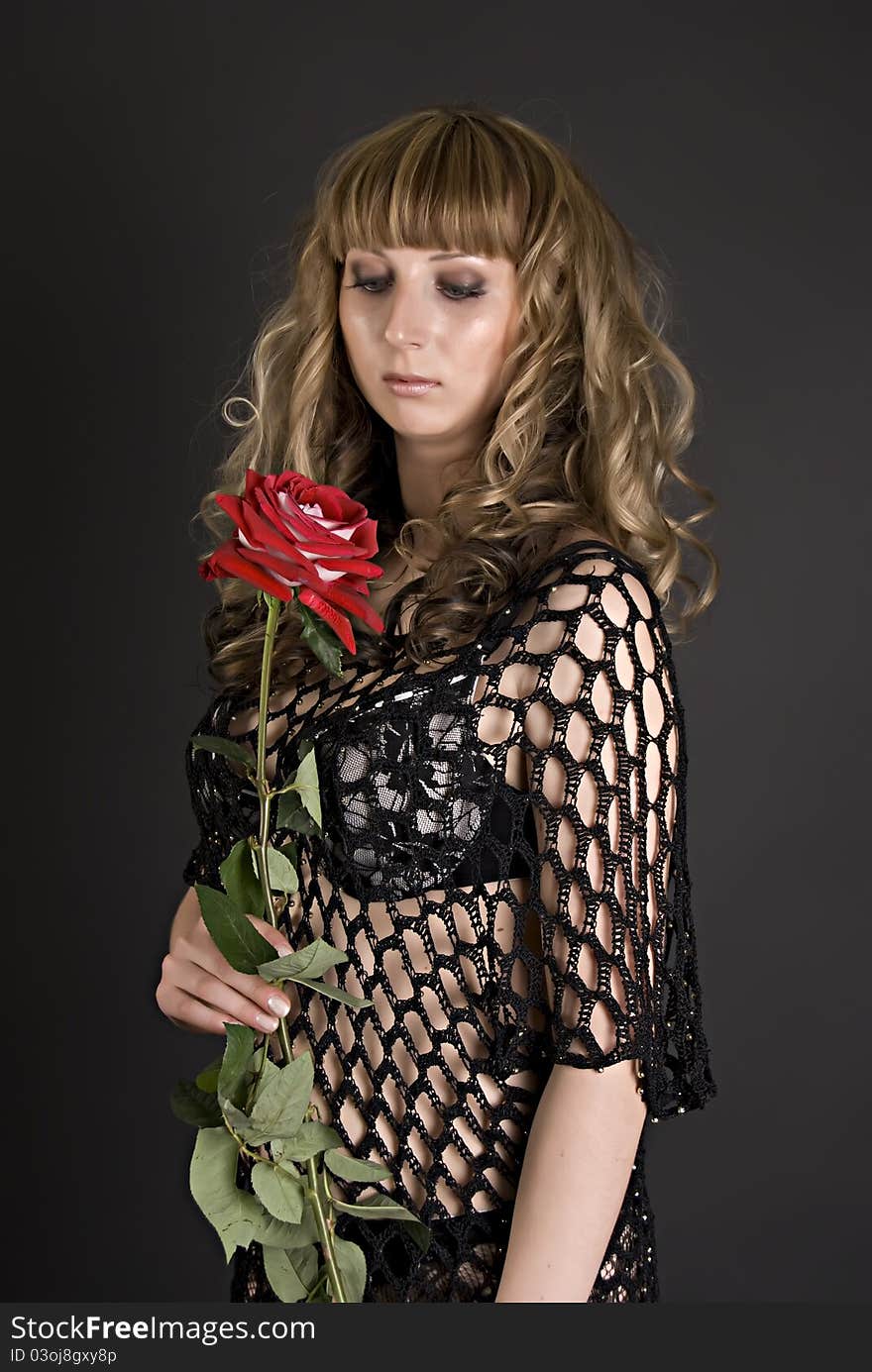 Beautiful girl with a red flower in hands. Beautiful girl with a red flower in hands