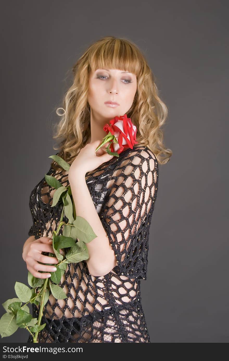 Beautiful girl with a red flower in hands. Beautiful girl with a red flower in hands