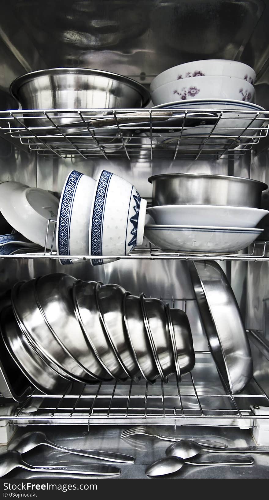 The inside view of an advanced disinfection bowl cabinet. Heating the kitchenware to destroy the bacteria.