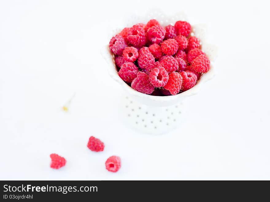 Bowl of raspberry on the white background. Bowl of raspberry on the white background