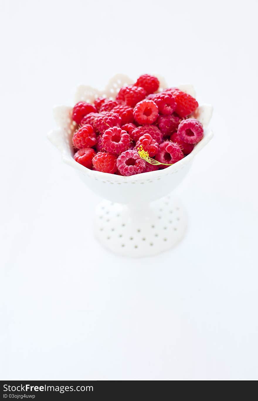 Bowl of raspberry on the white background. Bowl of raspberry on the white background