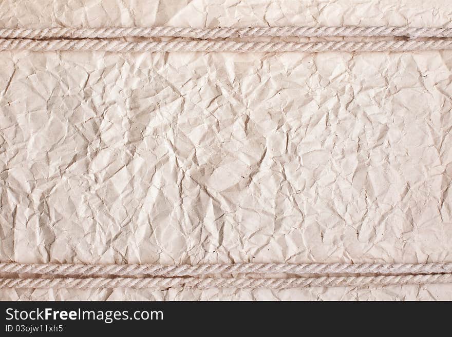 Crushed paper background with rope