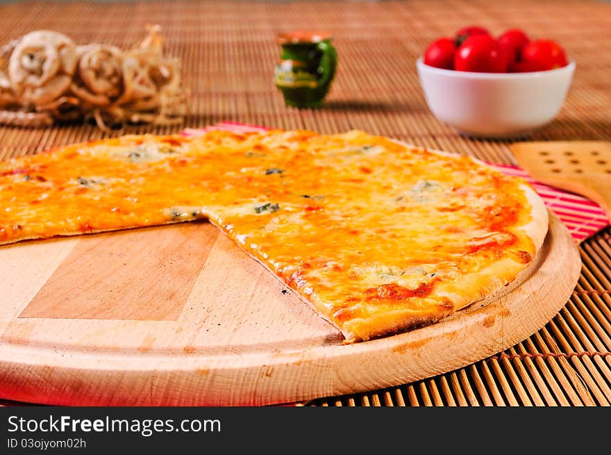 Italian pizza slice on table with small tomatoes