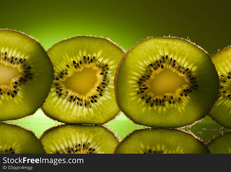 Green Kiwi in row on green background