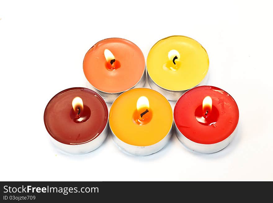 Red, orange and yellow candles on white background. Red, orange and yellow candles on white background