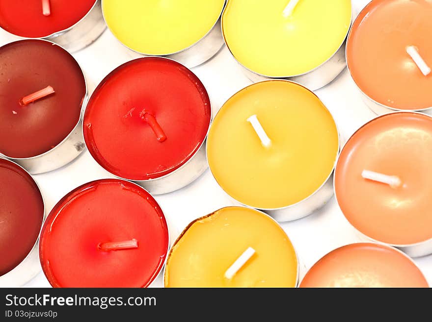 Red, orange and yellow candles on white background. Red, orange and yellow candles on white background