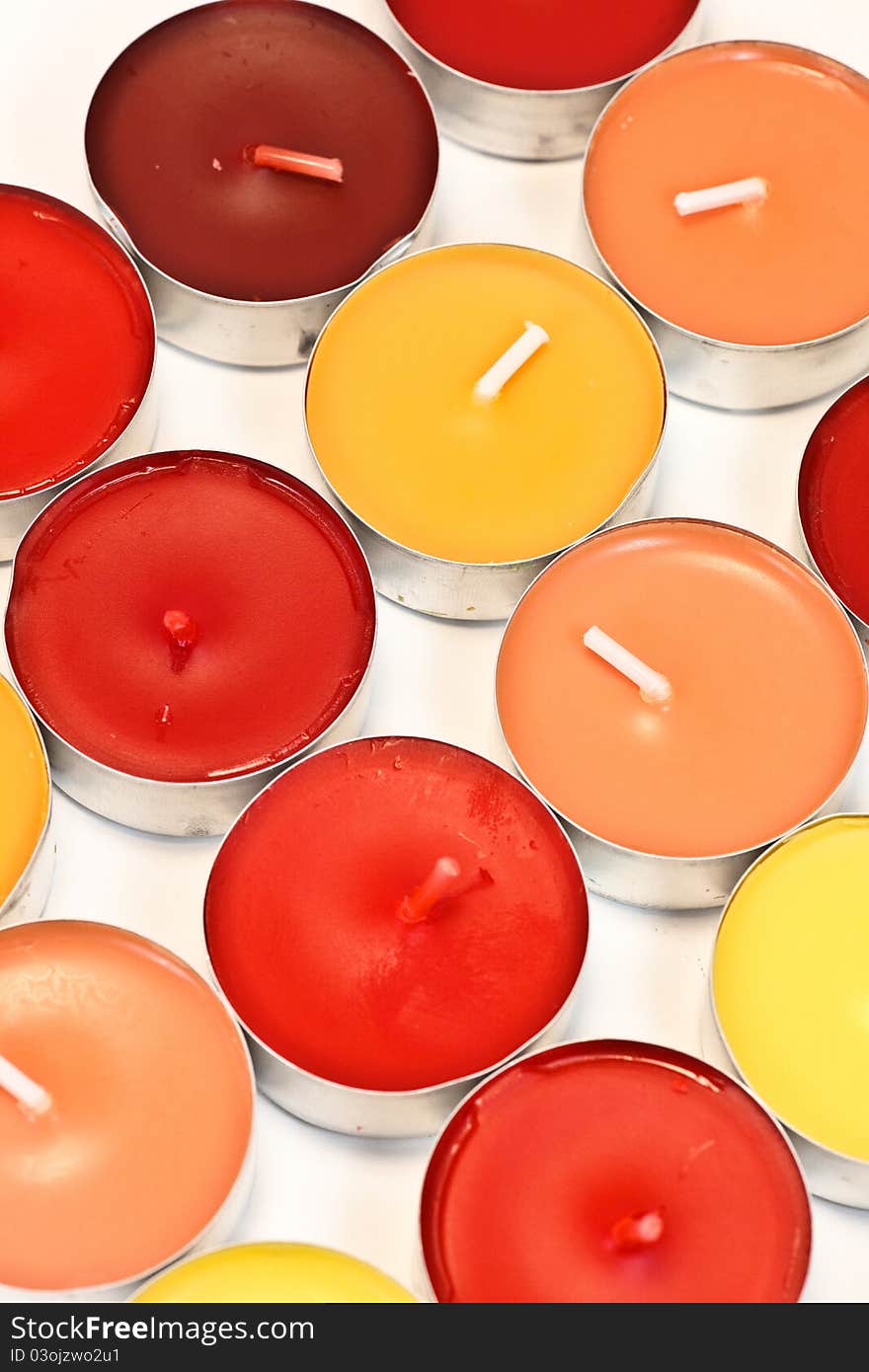 Red, orange and yellow candles on white background. Red, orange and yellow candles on white background