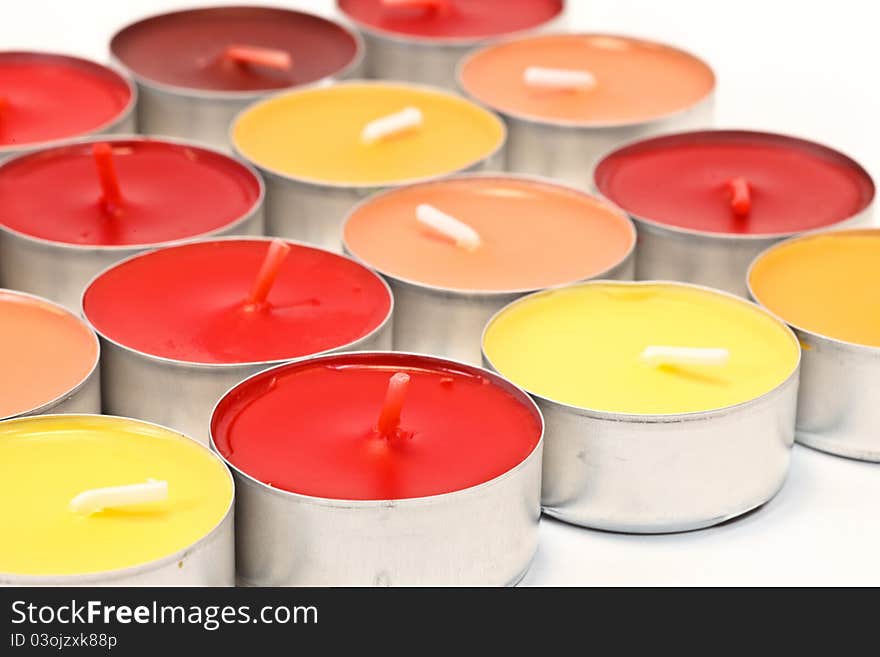 Red, orange and yellow candles on white background. Red, orange and yellow candles on white background