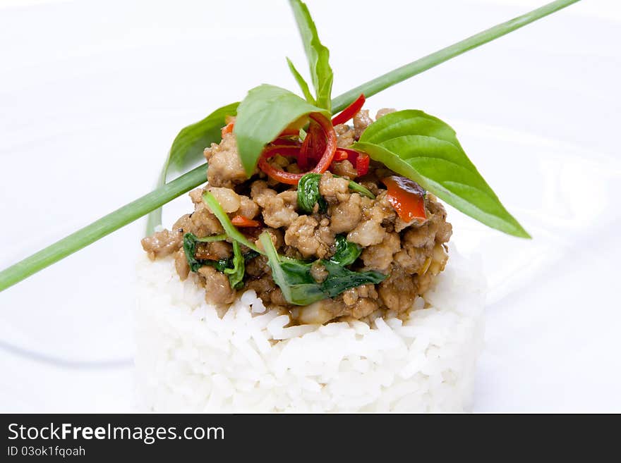 Spicy pork fried with hot basil on rice