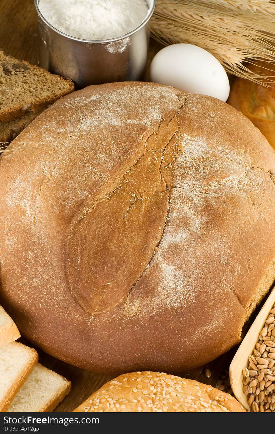 Bakery products and grain on wooden texture