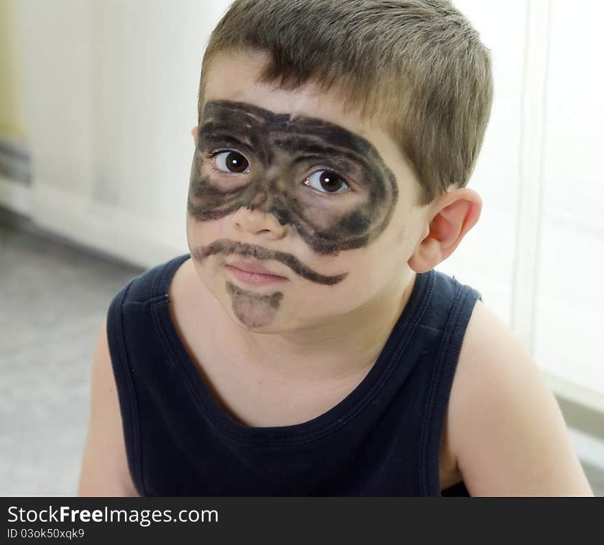 Lovely child with his face painted as El Zorro