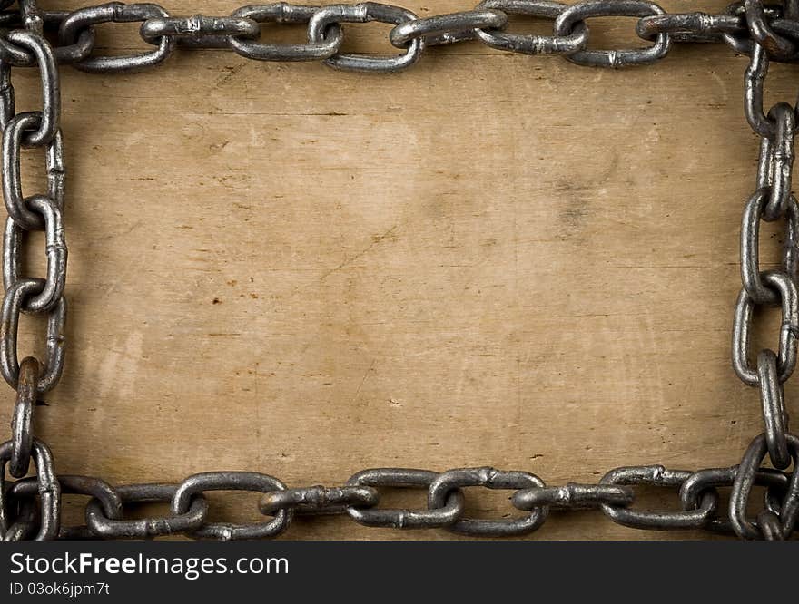 Metal chain on old wood background texture. Metal chain on old wood background texture