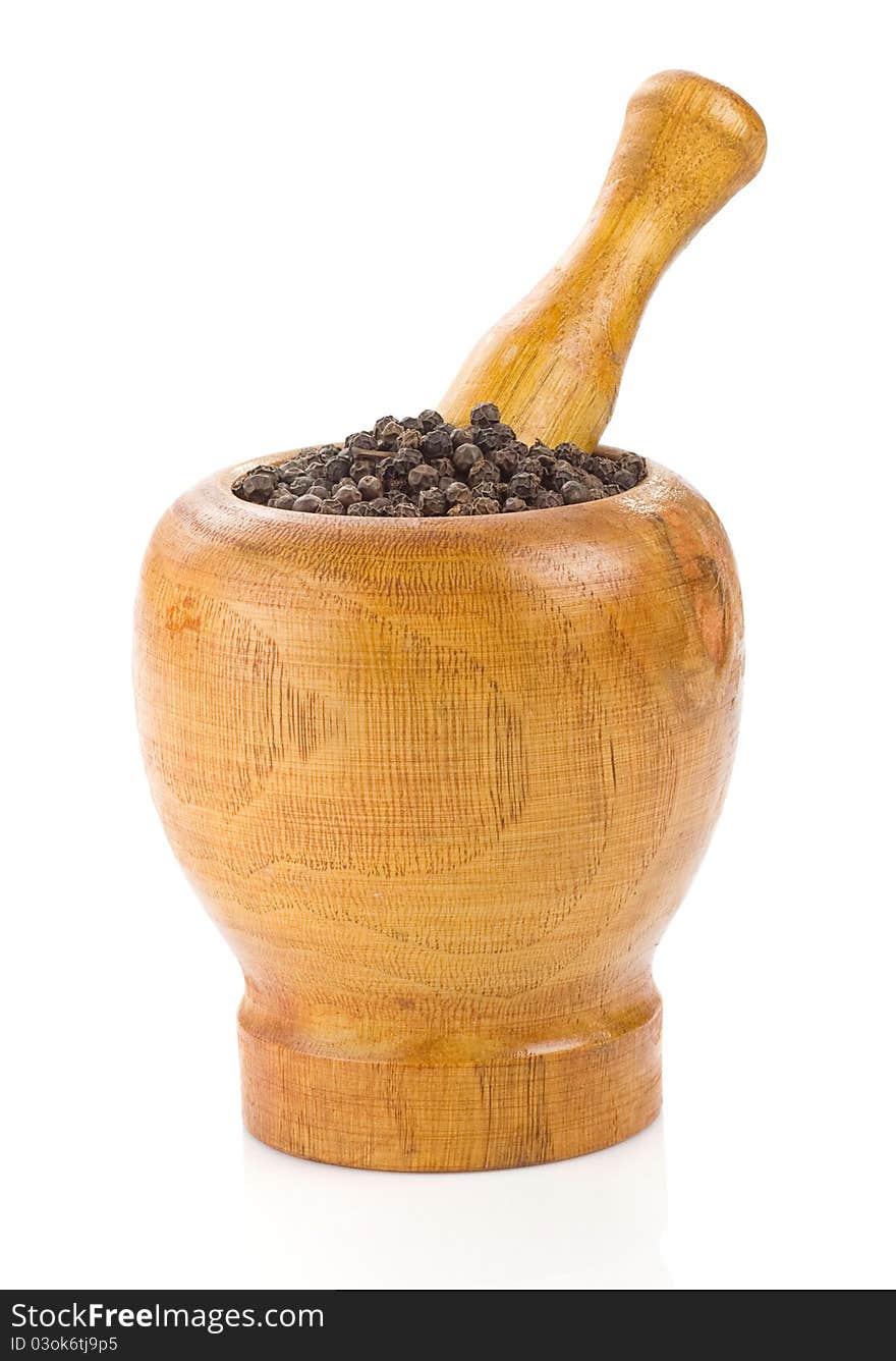 Pepper in mortar and pestle on white