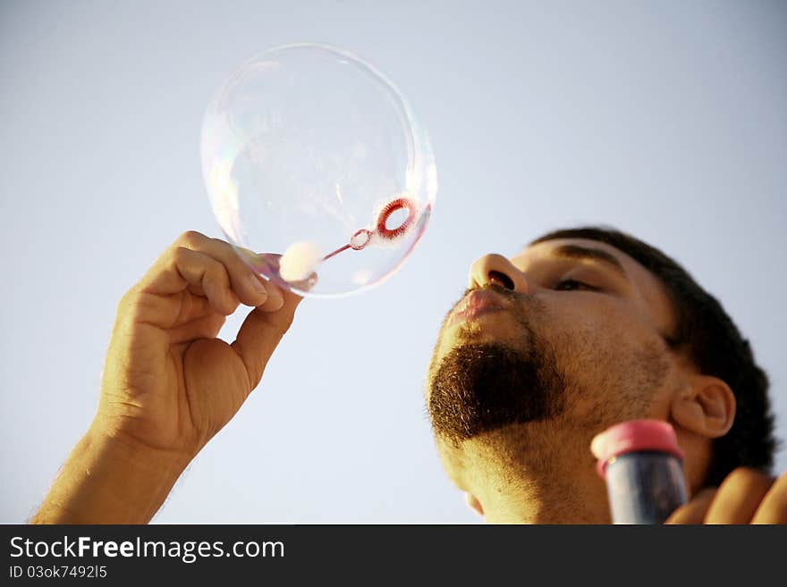 Man making bubbles in the sun