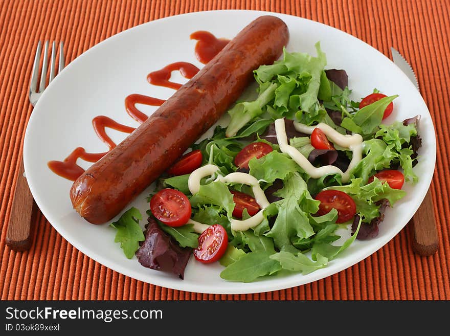 Fried sausage with salad and sauce