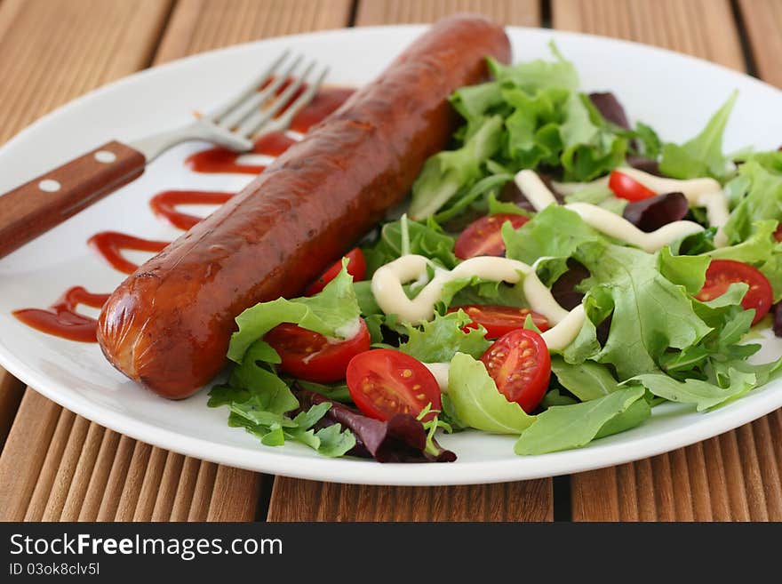 Fried sausage with salad