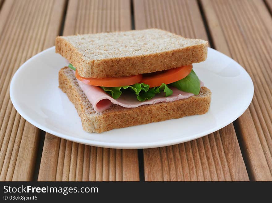 Toast with ham and tomato on a plate