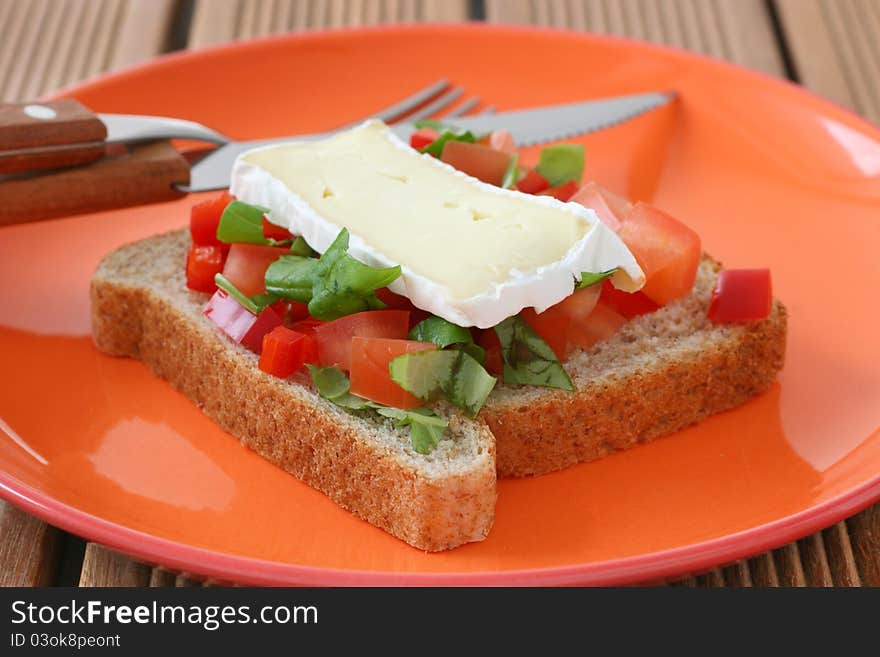 Toast with cheese camembert and cut tomato