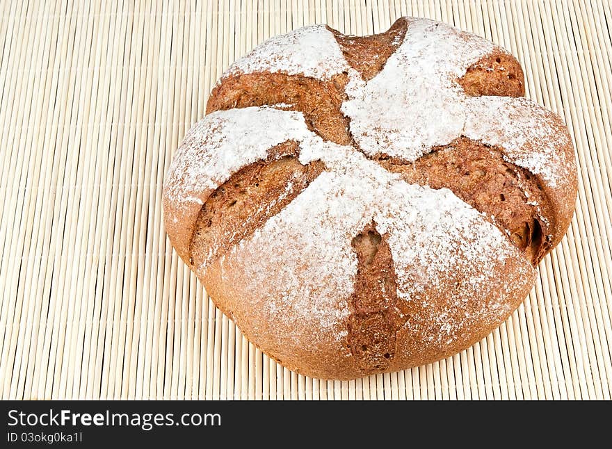 Loaf of rye bread on textured background