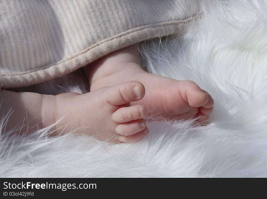 Newborn baby clutching mothers finger