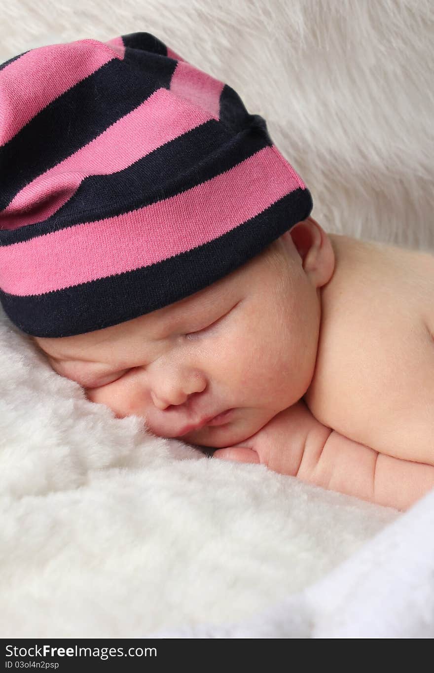 Newborn baby clutching mothers finger