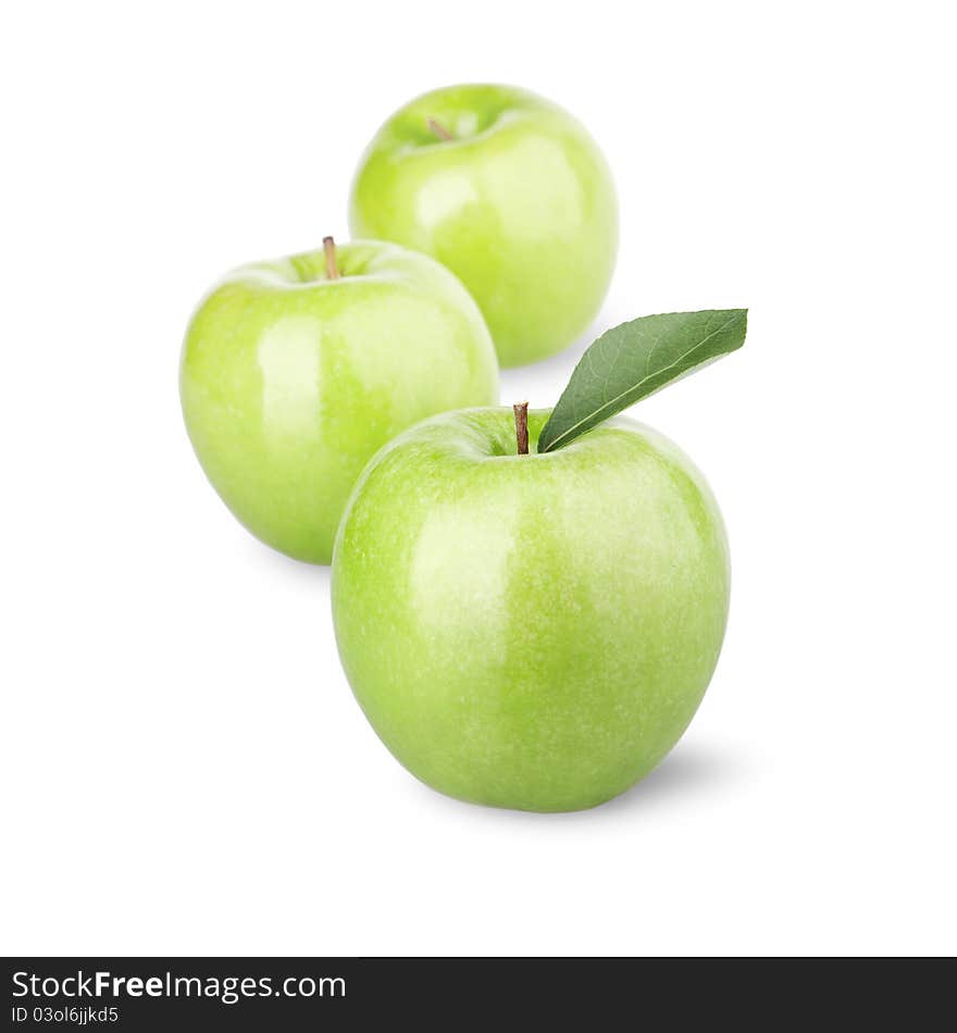 Group of green apples with a leaf. Isolated on a white background