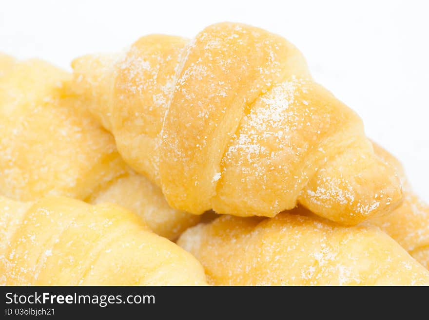 A group of croissants with icing on white background