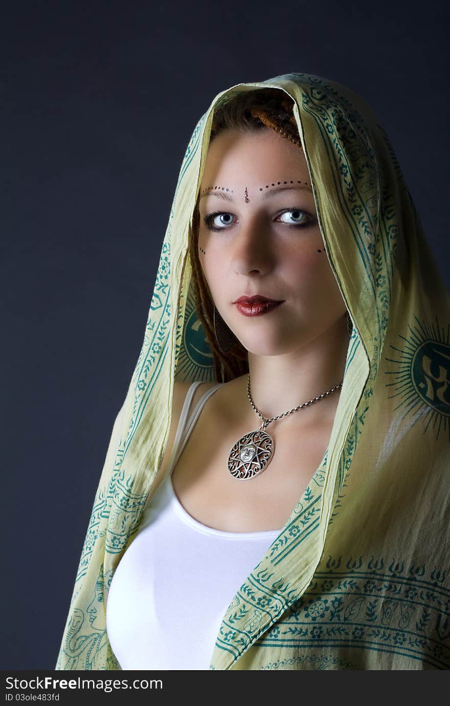 Portrait of young girl stylized as indian in studio