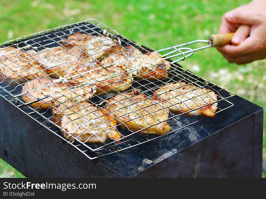 Steaks in Barbecue grill in cook's hands