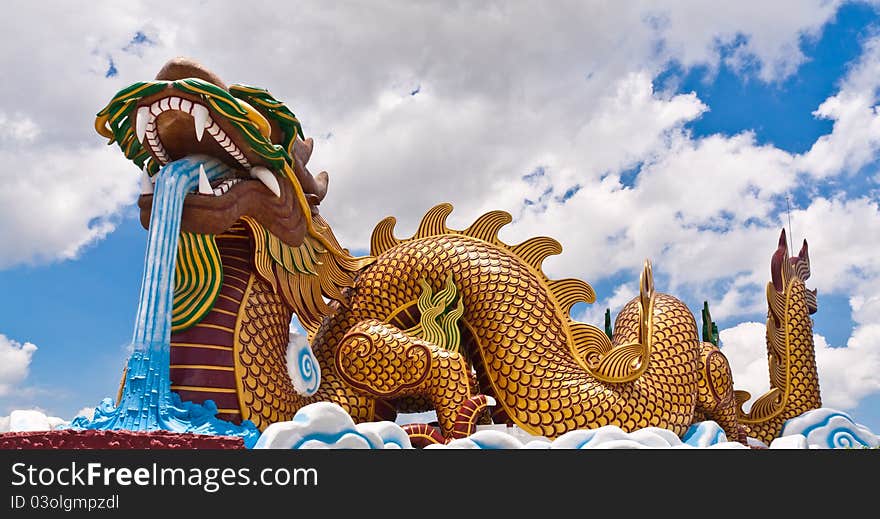 Golden dragon statue with blue sky