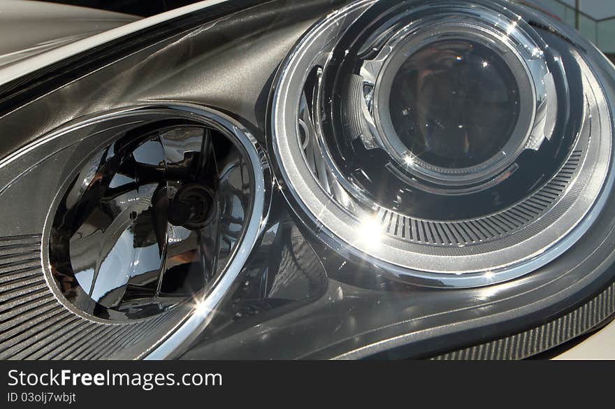 The front leadlight of a modern sportscar. shows the beauty of modern engineering and streamlining. The front leadlight of a modern sportscar. shows the beauty of modern engineering and streamlining