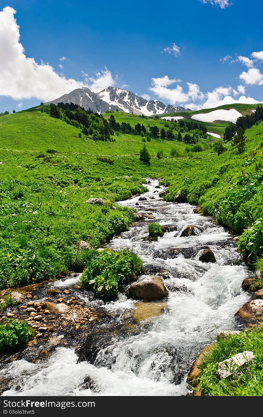 Summer landscape with green grass, mountains and river. Summer landscape with green grass, mountains and river