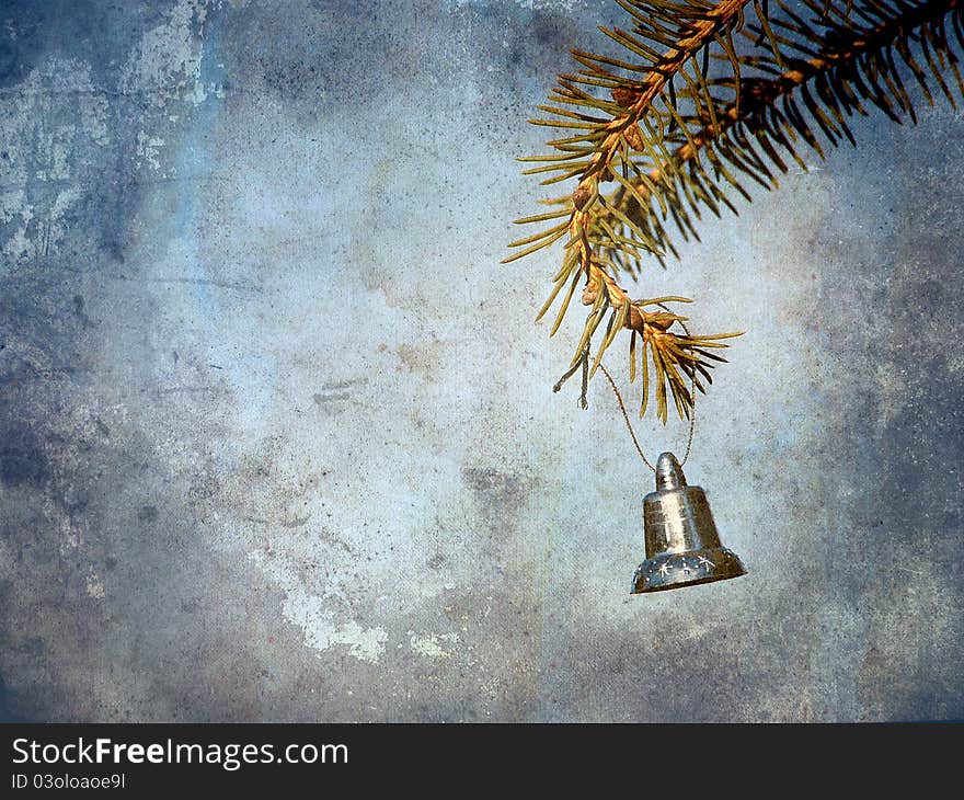 Vintage style antique textured image of a little silver bell hanging from a pine branch with copy space. Vintage style antique textured image of a little silver bell hanging from a pine branch with copy space.