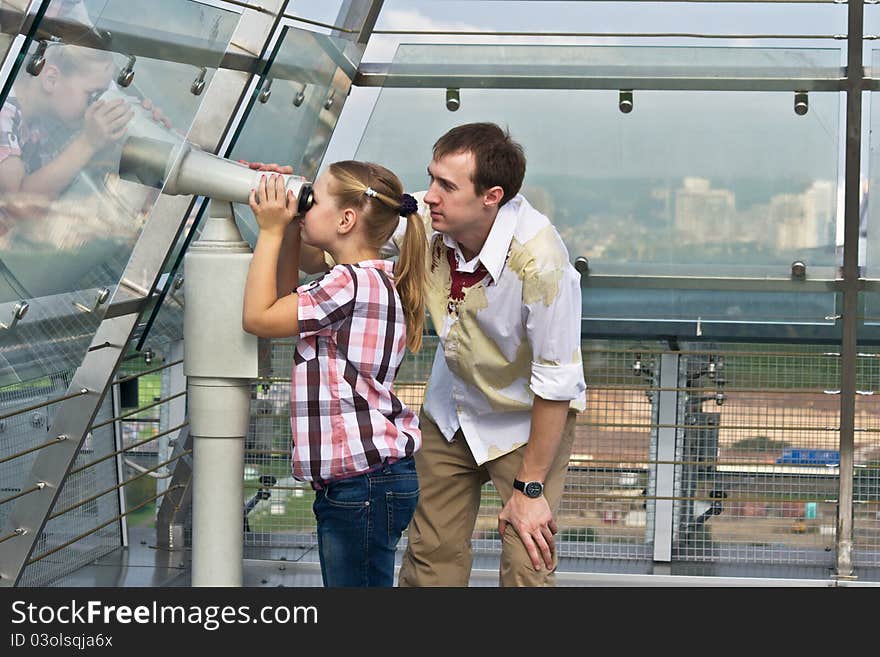 Father And Daughter Looking Through Telescope