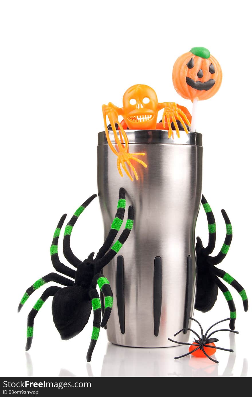 Halloween cup with spiders, hell candies, skeleton, lollipop on a white background. Halloween cup with spiders, hell candies, skeleton, lollipop on a white background