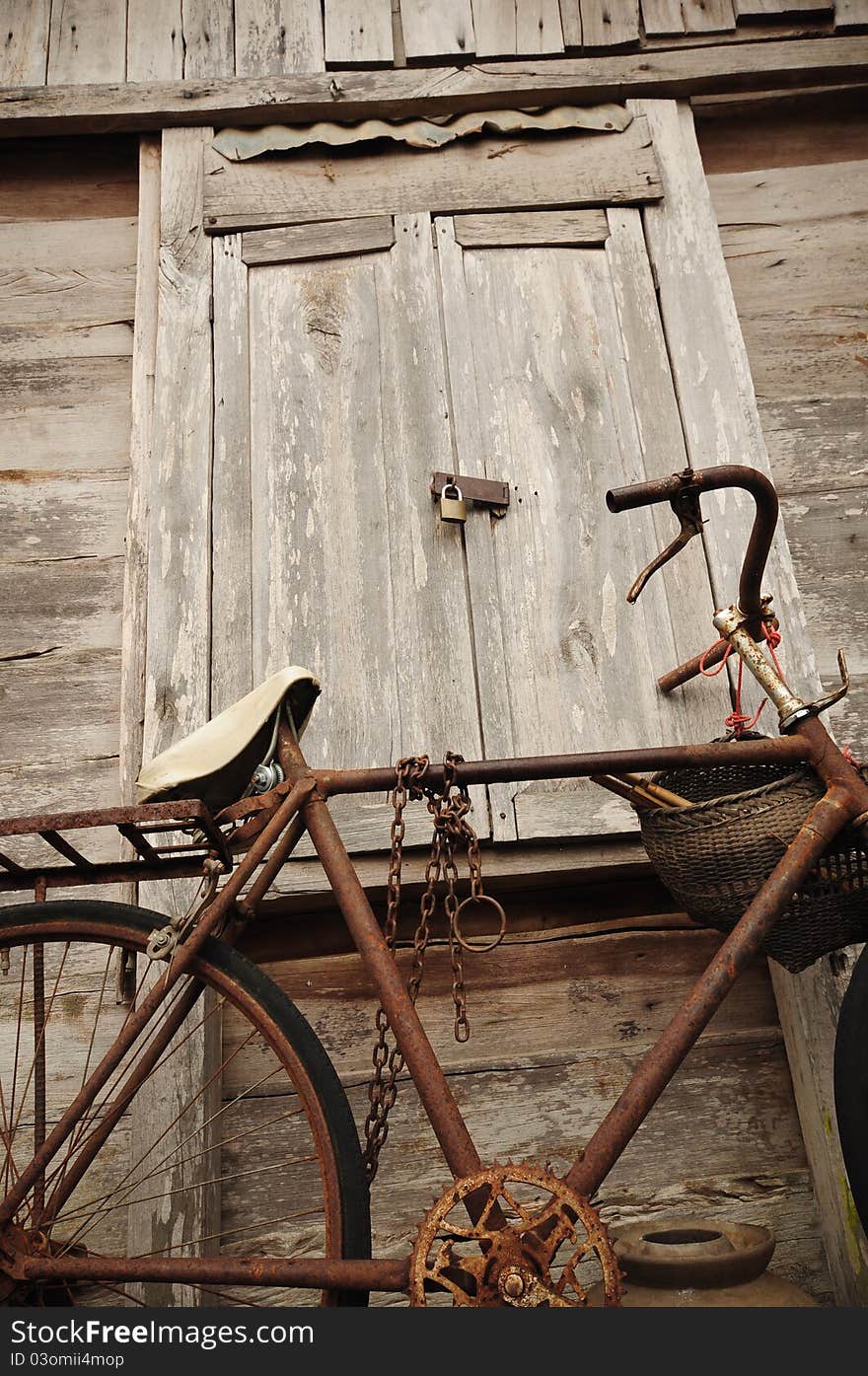 Image of Old Bicycle and old wood house