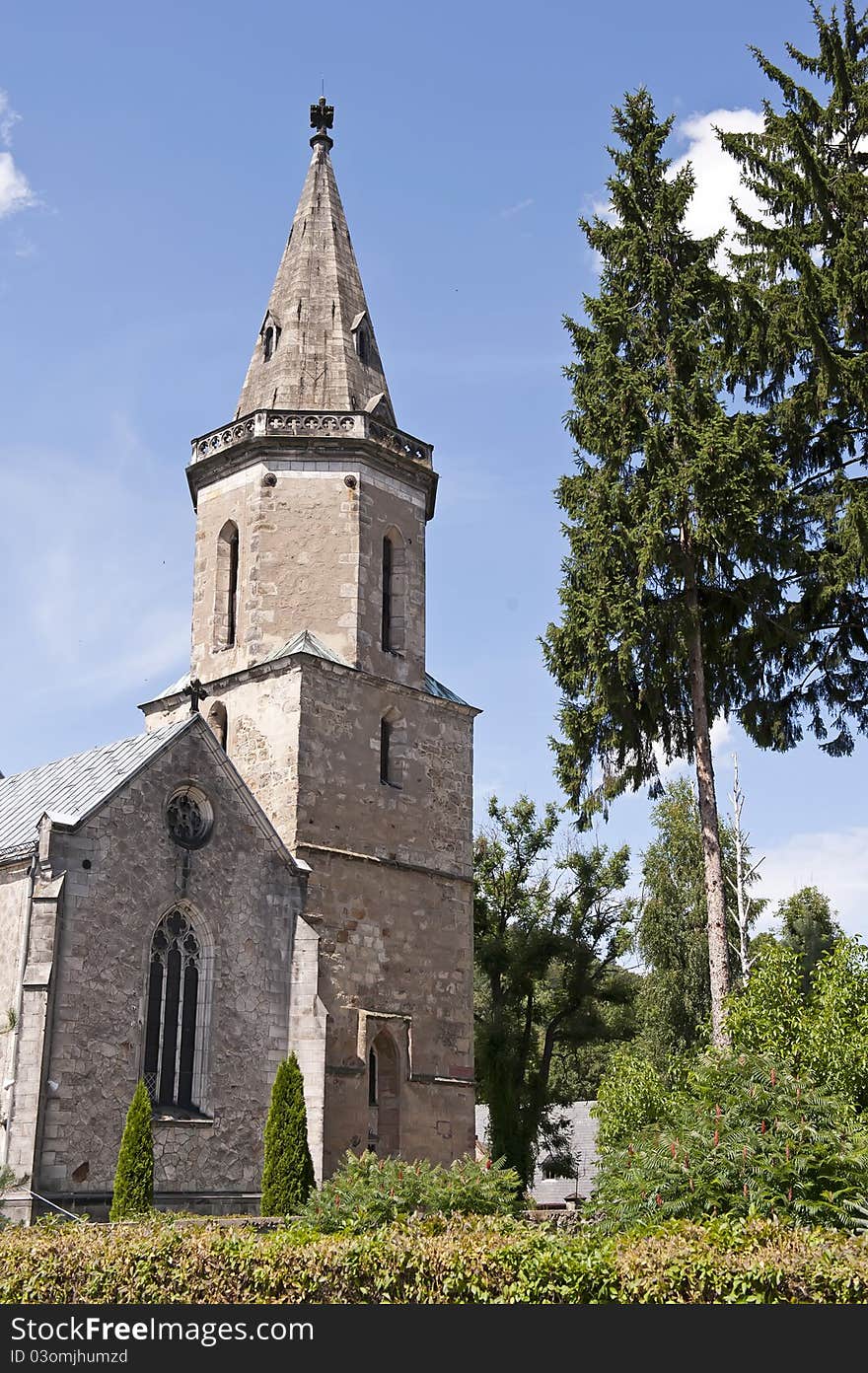 Architecture of the old stone church on the summer sunny day.