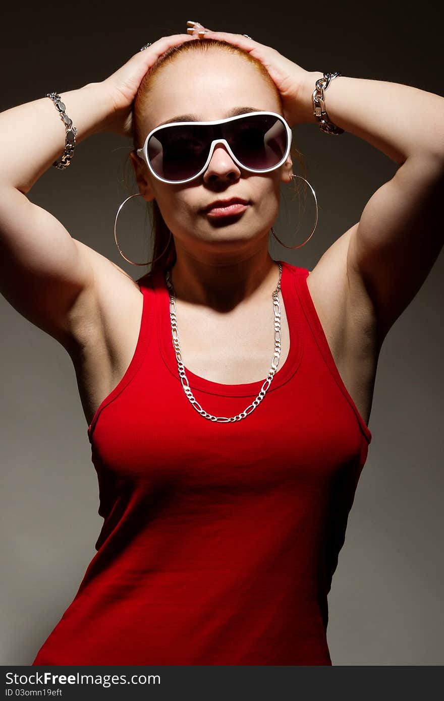 Fashionable hip-hop girl posing in studio